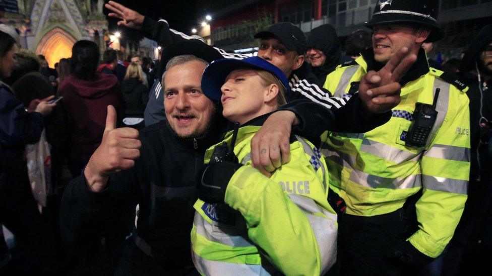 Police officers and fans