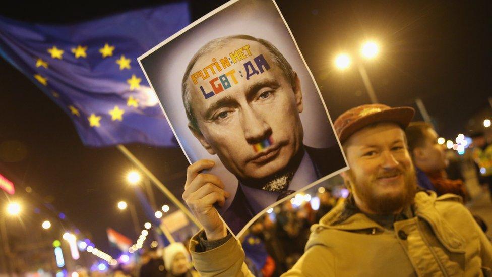 Demonstrators, including one bearing a portrait of Russian President Vladimir Putin and another waving a flag of the European Union, march to protest against a visit to Budapest by Putin as well as against the government of Hungarian Prime Minister Viktor Orban in February 2015 in Budapest, Hungary