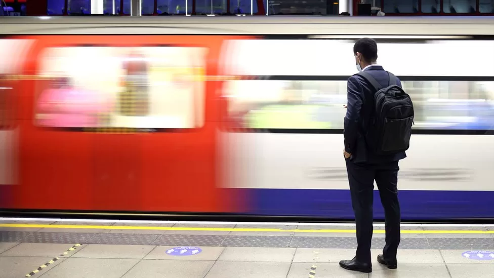 Man in The Underground platform as train passes