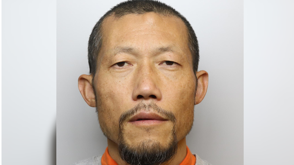 A police mugshot of Hongchi Xiao