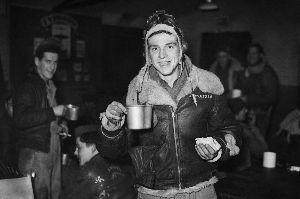 Sergeant Leo Teetman Jr celebrates New Year's Eve, 1943, with a post-mission sandwich and coffee