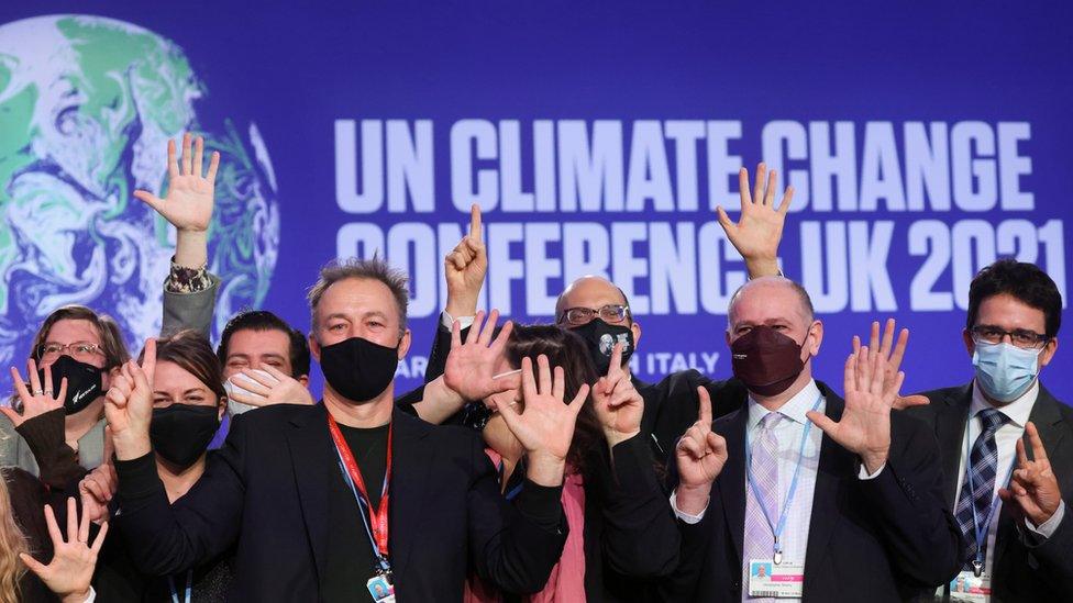 Delegates pose for a picture during the UN Climate Change Conference (COP26) in Glasgow, Scotland