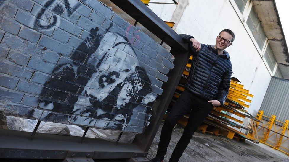 Restorer Chris Bull with the Snorting Copper wall in its steel frame