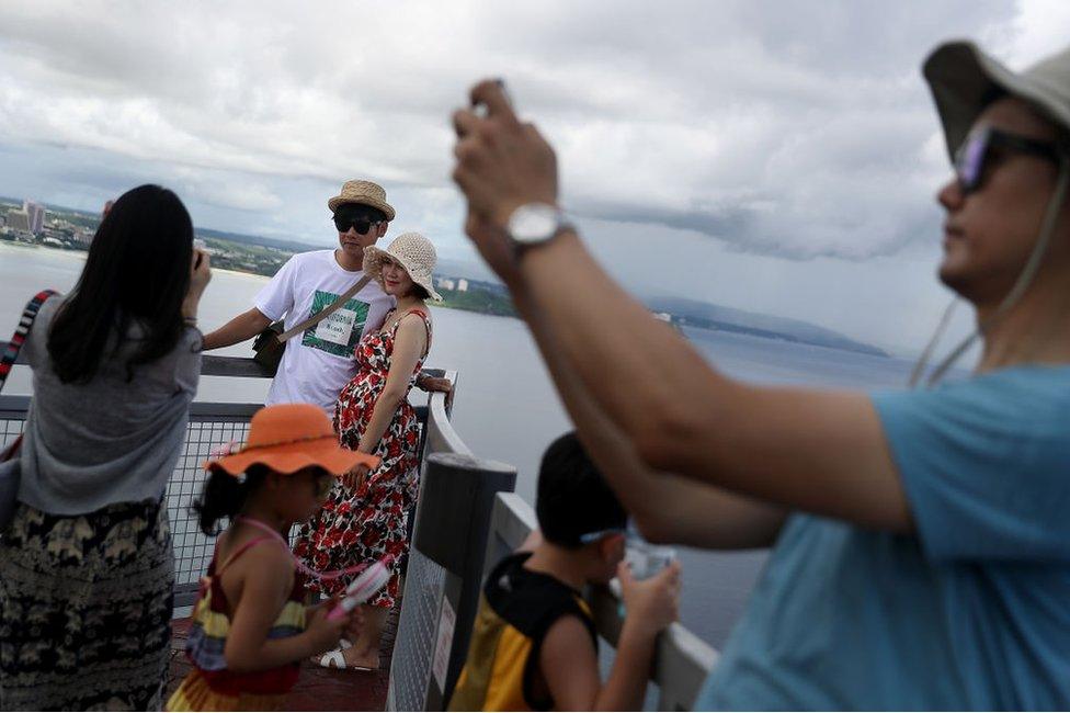 Tourists take pictures at Two Lovers Point on 16 August 2017 in Tamuning, Guam.