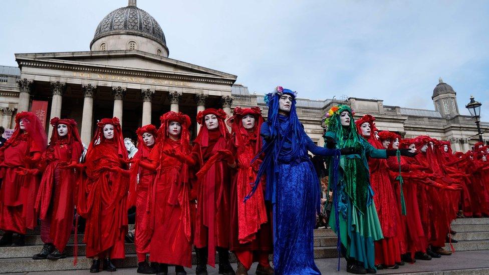 Climate activists protest on the steps of the National Gallery in Trafalgar Square