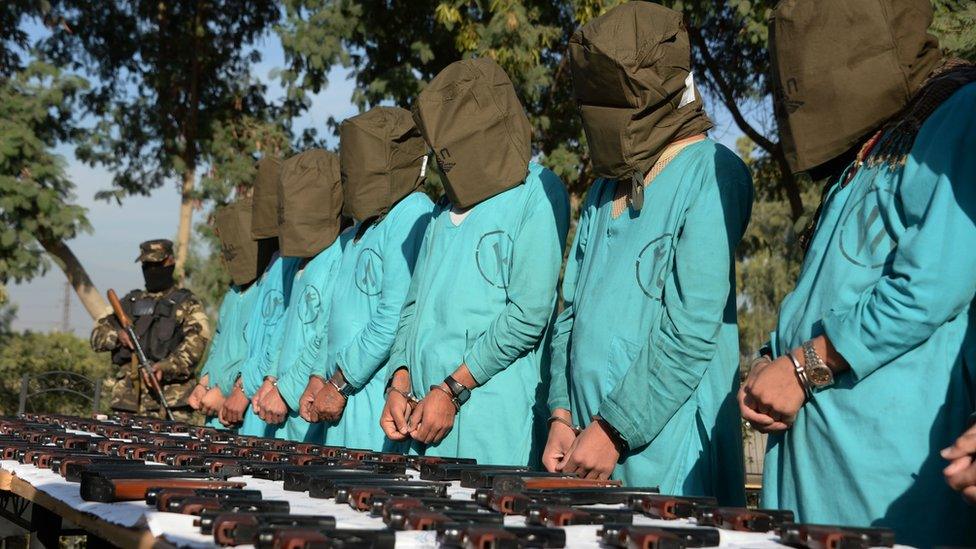 Suspected Islamic State (IS) and Taliban militants are brought before media during a press conference in Jalalabad on December 6, 2016.