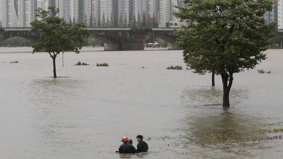 Firefighters rescue a man from flooded Taehwa river in Ulsan, South Korea, September 6, 2022.