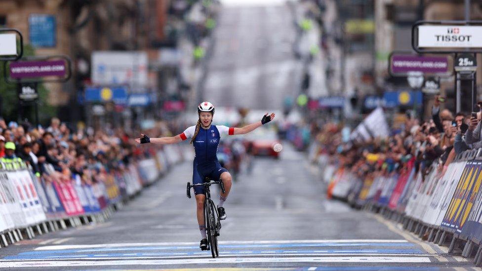 Julie Bego of France celebrates at finish line as gold medal winner during the women junior road race in the 96th UCI Cycling World Championships Glasgow 2023,