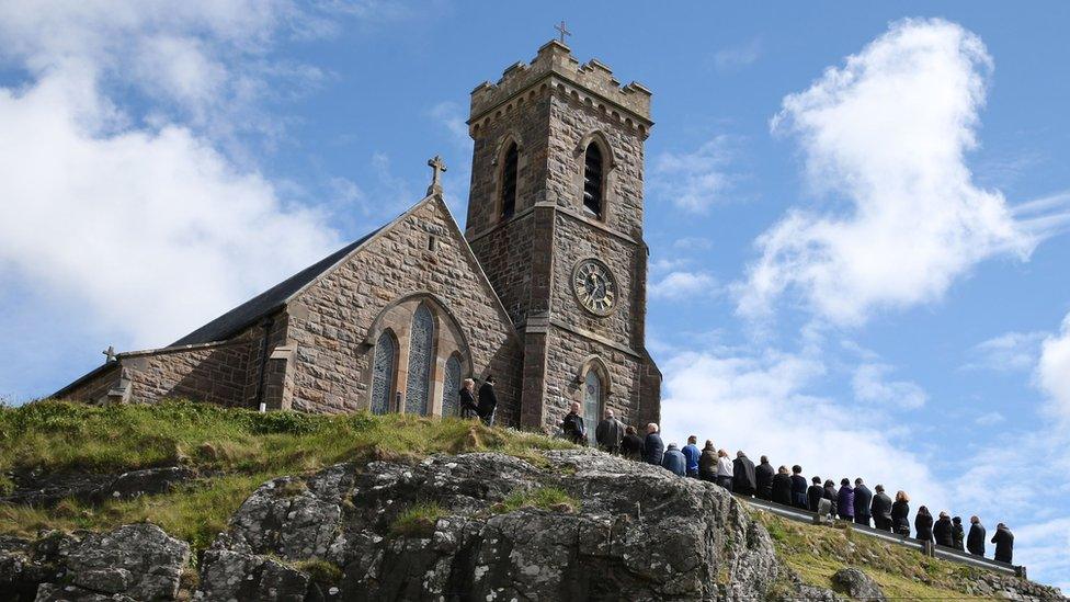 Mourners gather for the funeral mass