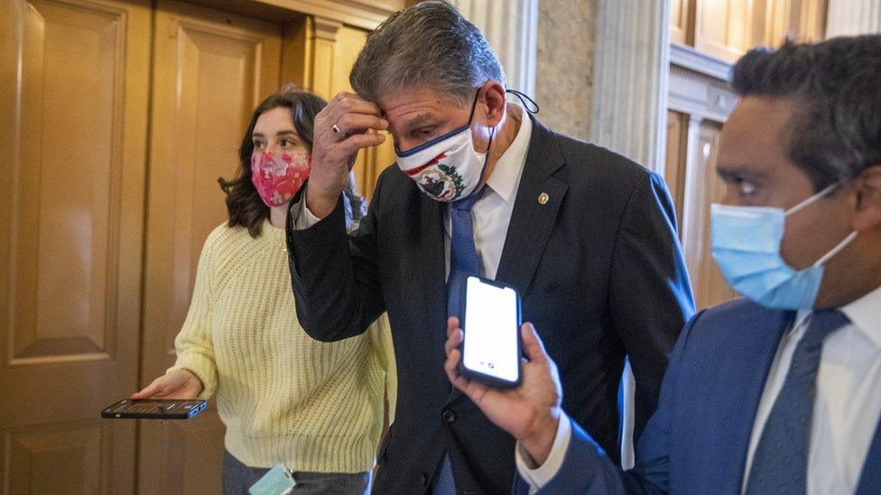 Joe Manchin responds to a question from the news media as he walks to the Senate floor to vote in the US Capitol in Washington, DC, USA, 05 March 2021