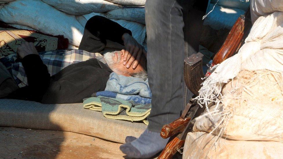 A Free Syria Army fighter rests in al-Tamorah, in the north of Aleppo province, 28 February