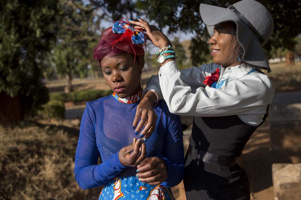 Chisala Musasha prepares a model for a photo shoot