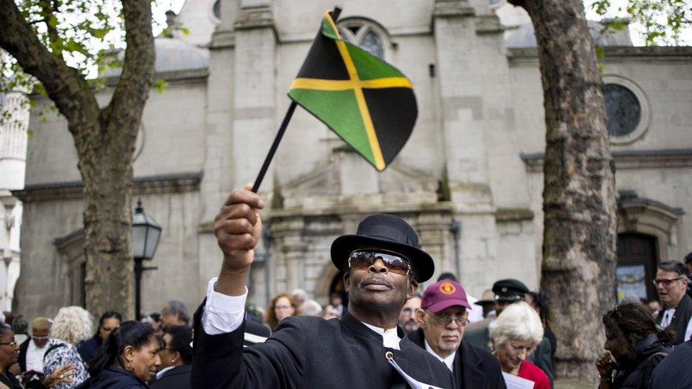 A mourner waving the Jamaican flag o