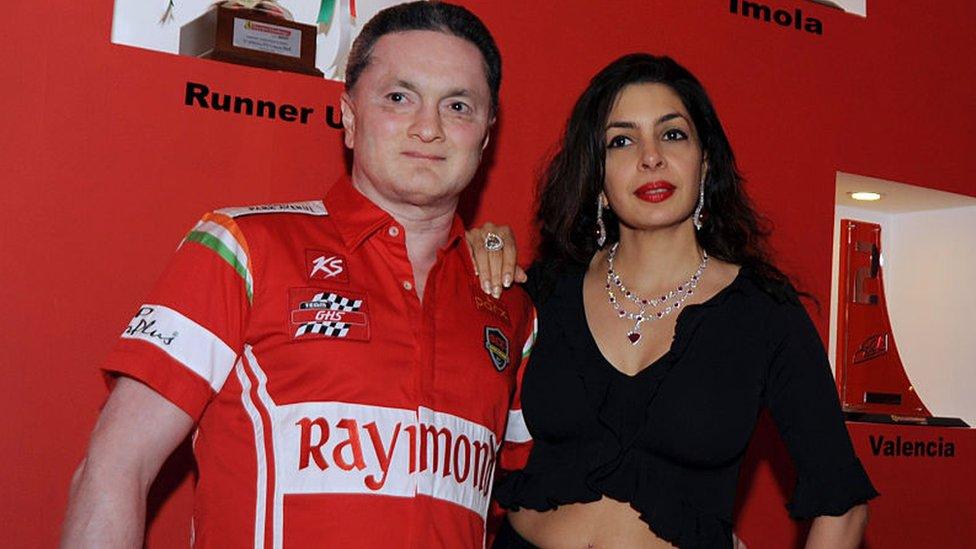 Indian racer and businessman Gautam Singhania (L) poses with his wife at his success party for the European Ferrari Challenge 2015, in Mumbai on December 1, 2015. AFP PHOTO / AFP / STR (Photo credit should read STR/AFP via Getty Images)