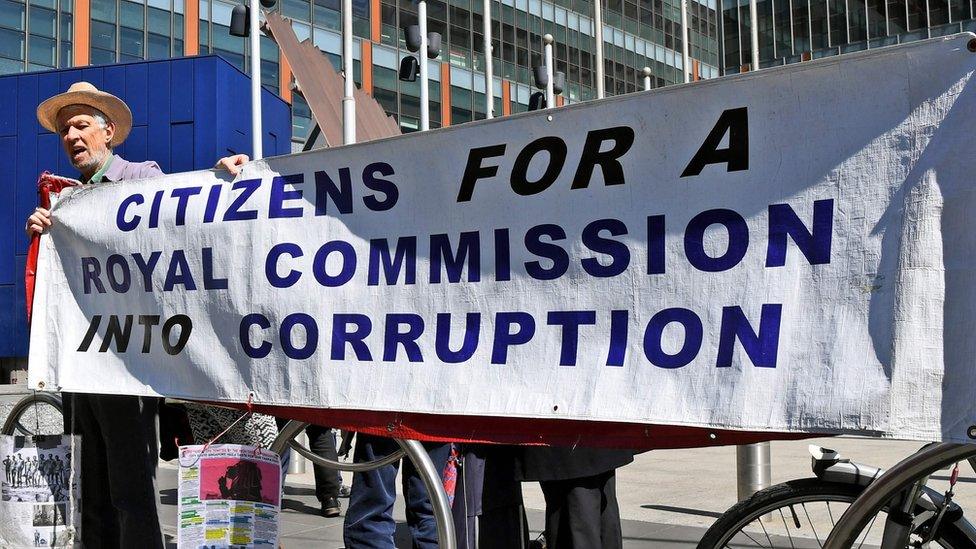 A protest outside an inquiry public hearing into the banking sector