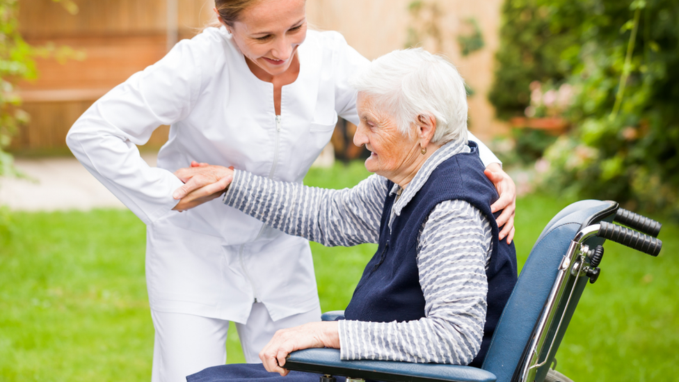 Carer helping patient