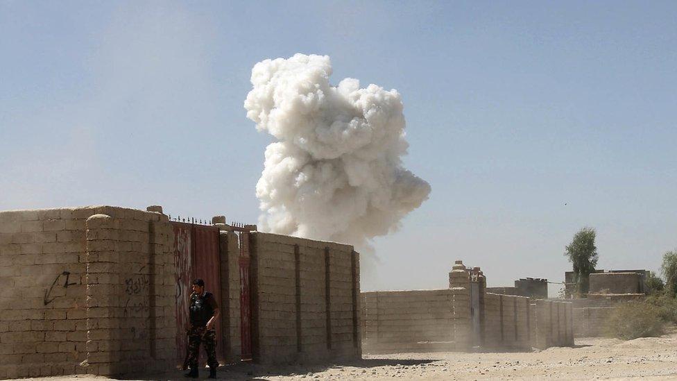 Smoke rises after a suicide attack in Lashkar Gah the capital of southern Helmand province of Afghanistan, Monday, Oct. 10, 2016