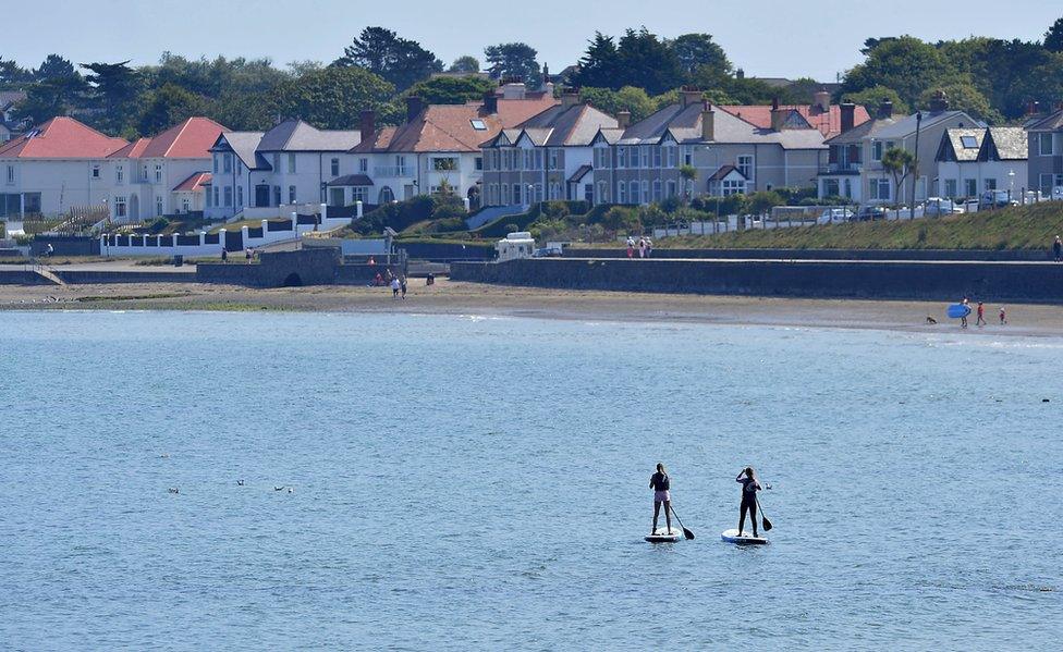 Two women on paddleboards in the water at Ballyholme Bay in Bangor in County Down