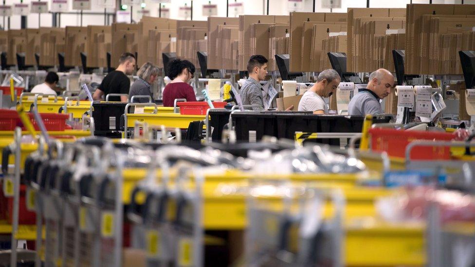 Employees of American electronic commerce company Amazon prepare products for dispatch in Bad Hersfeld, central Germany on December 7, 2017.