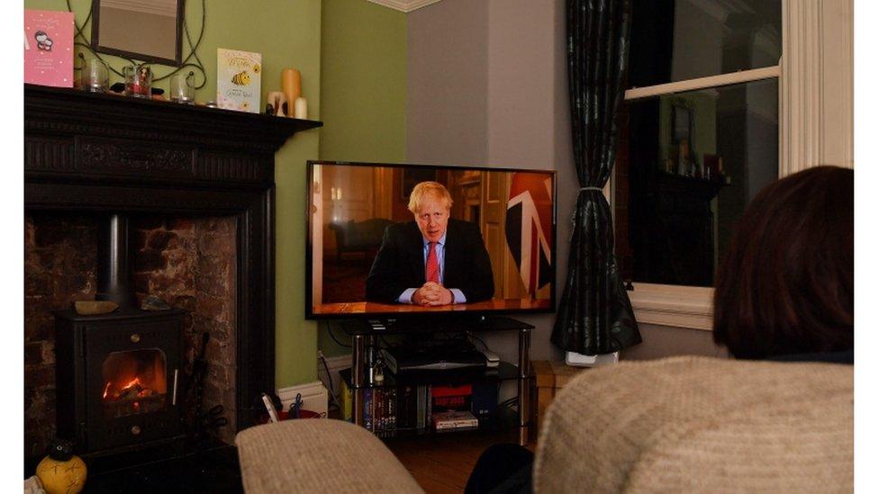 Woman watching Boris Johnson on television