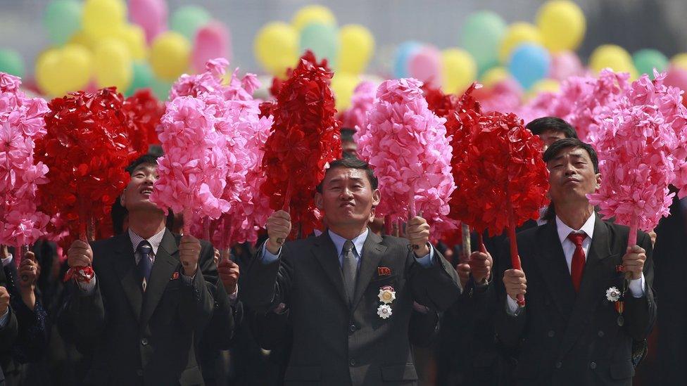 A group of North Korean men with pom-poms