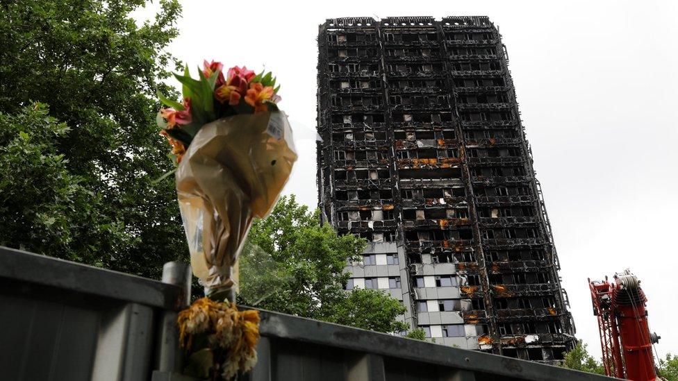 A floral tribute is seen near the Grenfell Tower