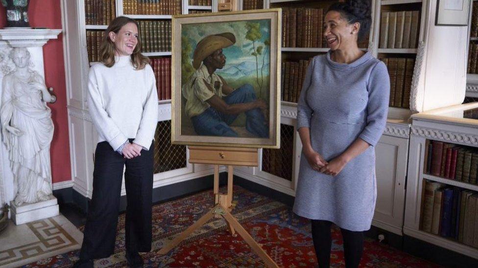Two women with a painting