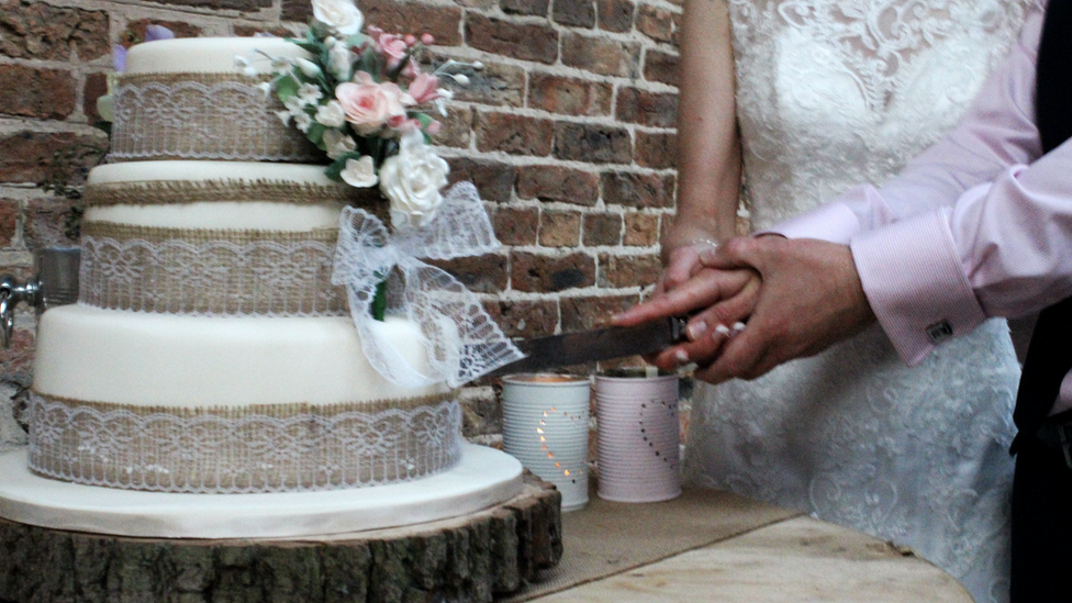 Couple cut a wedding cake