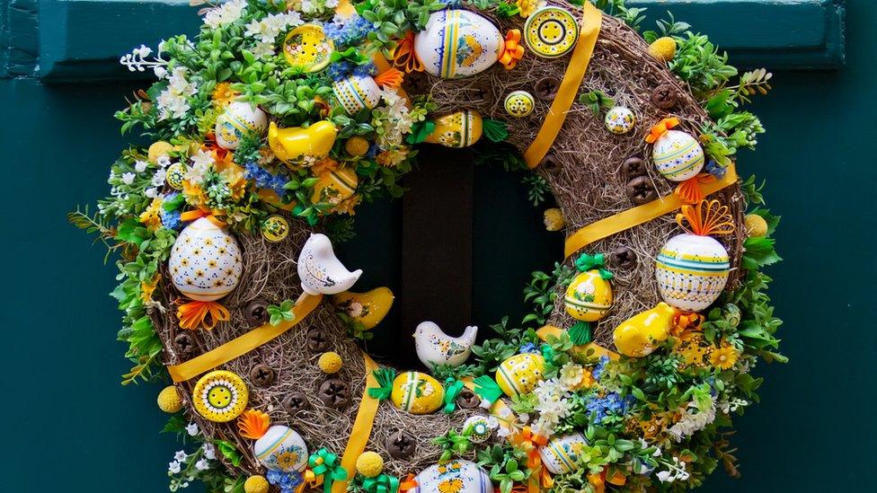 Handmade wreath with eggs, ribbons and figures of birds for easter