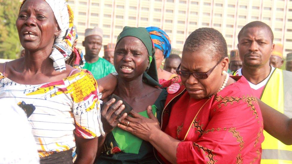 Coordinator of the 'Bring Back Our Girls' Nierian movement Oby Ezekwesili (R) helps a mother sobbing