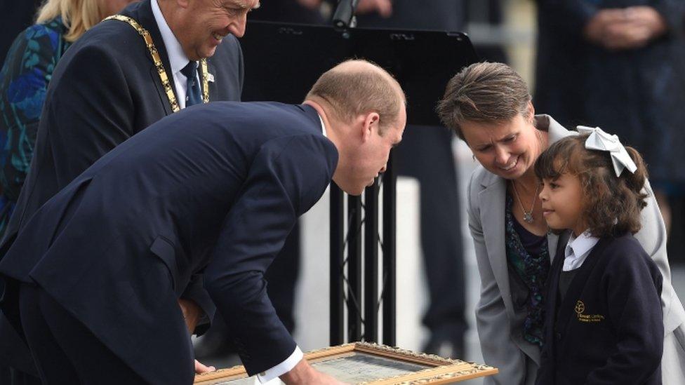 The Duke of Cambridge receives a gift from a young girl