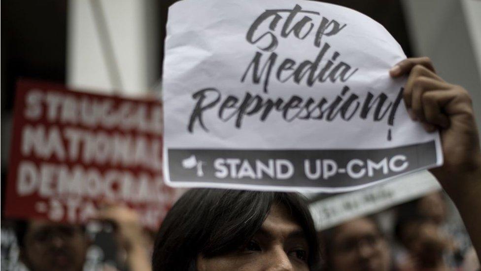 Students of the University of the Philippines participate in a protest to defend press freedom in Manila