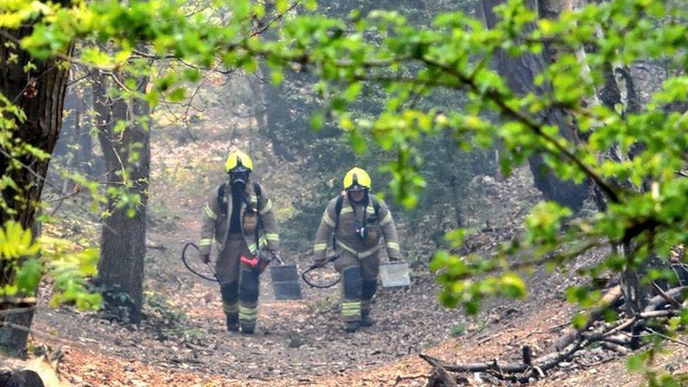 Two firefighters at the scene of the fire