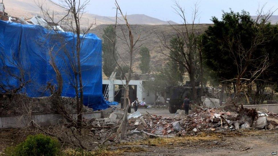 Wreckage in front of a Turkish military police station, which has been covered by a tarpaulin, after a suicide attack 02/08/2015