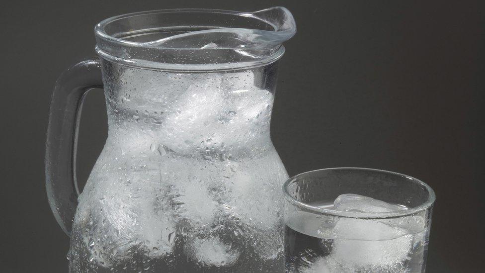 Iced water in jug and glass