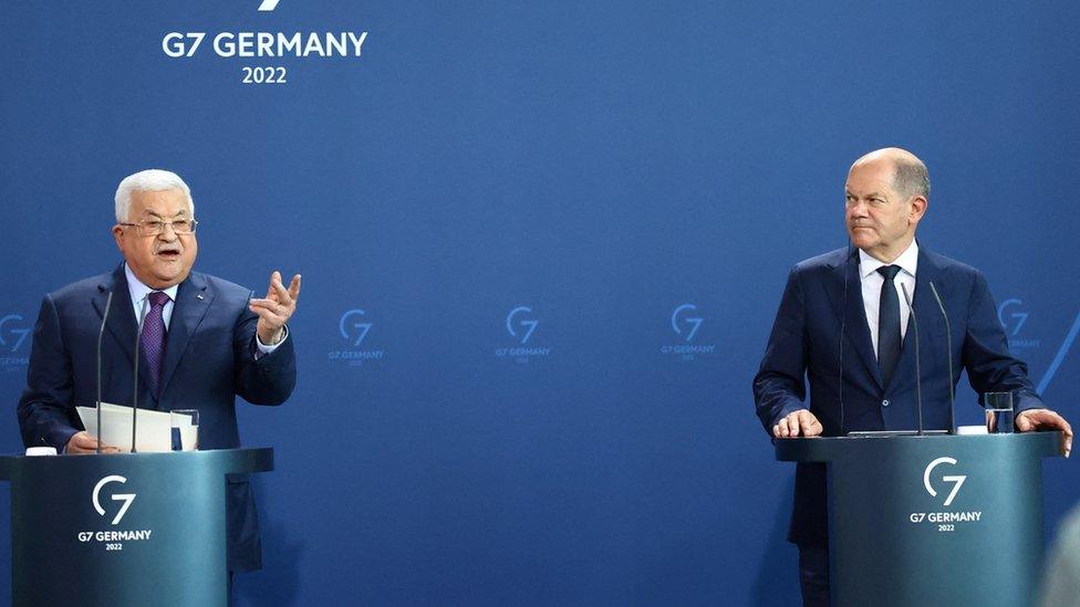 German Chancellor Olaf Scholz (R) watches as Palestinian President Mahmoud Abbas (L) speaks during a news conference at the Federal Chancellery in Berlin, Germany (16 August 2022)