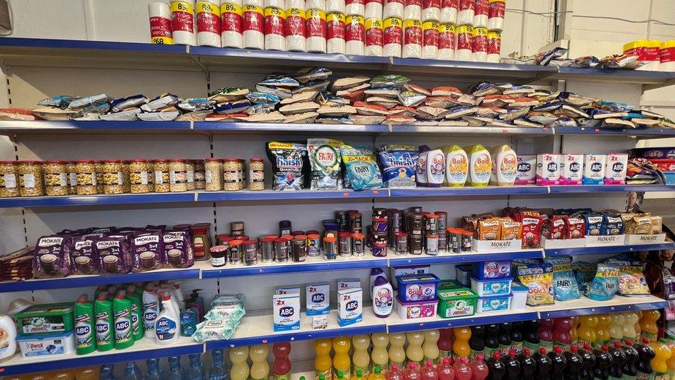 Food products and washing tablets lined up on shelves in one of the raided shops