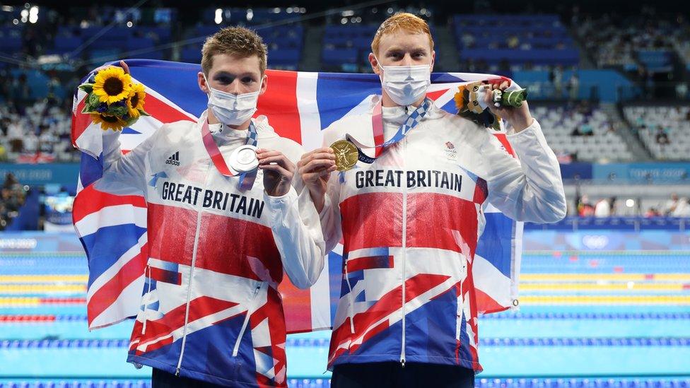 Silver medalist Duncan Scott of Team Great Britain and gold medalist Tom Dean of Team Great Britain pose with their medals for the Men's 200m Freestyle Final