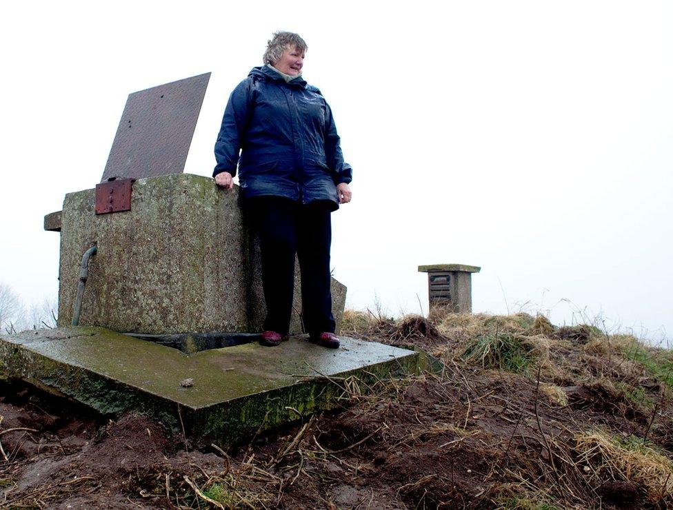 Rosemary 'Christine' Wright stands next to the entrance of a bunker monitoring post on the East Yorkshire Coast