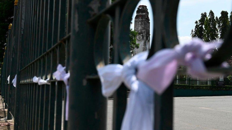 White ribbons tied on a fence at a cemetery in protest against the government policy of forced cremations of Muslims who die of the coronavirus - Colombo, December 14, 2020.