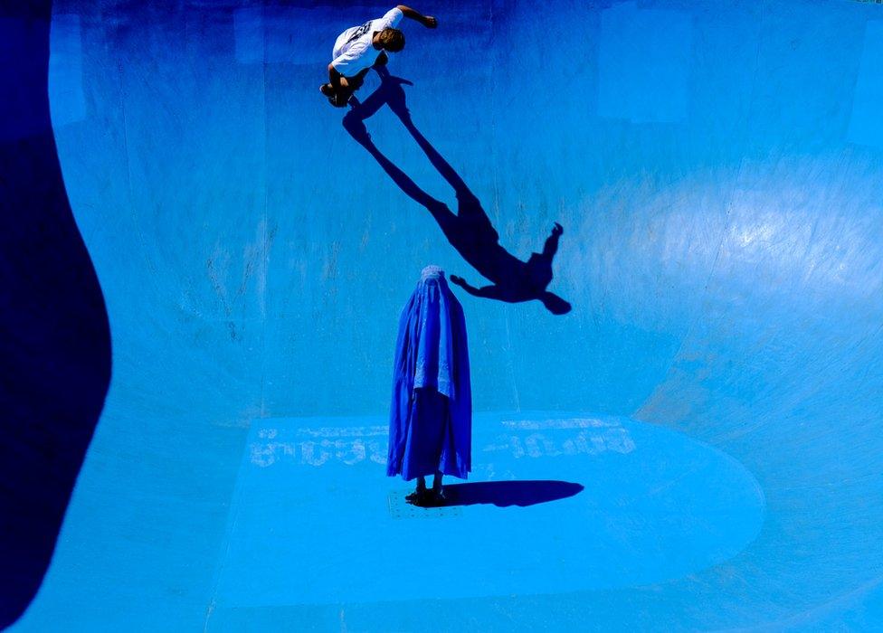 The final image in Muir's series showing a woman in a burka standing in a bright blue skate park