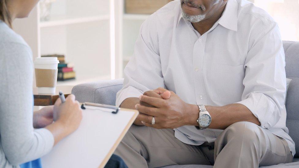 Woman interviews man stock image.