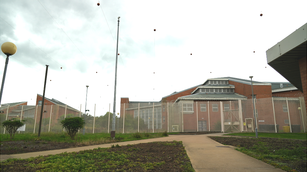 Outside of HMP Woodhill that shows high fences around the buildings