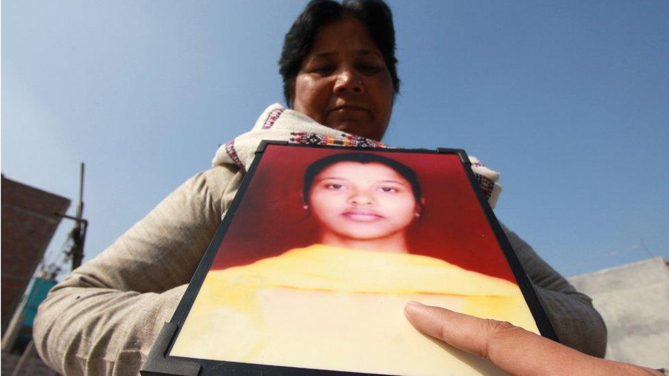 Ms Francis with a picture of her daughter Nikki