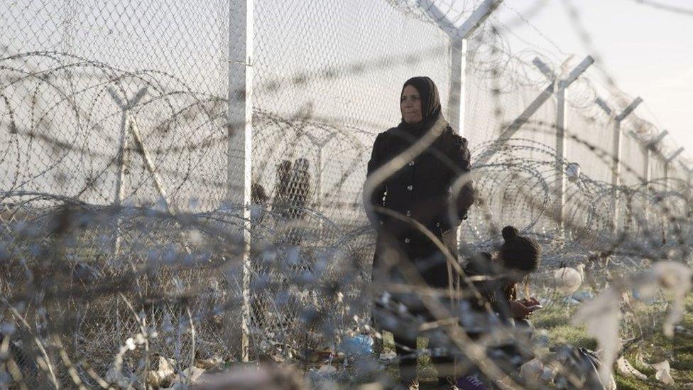 Two women near the border crossing that separates Greece from Macedonia at the northern Greek border station of Idomeni (02 March 2016)