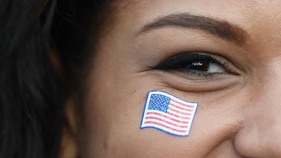 A woman with a US flag sticker on her face