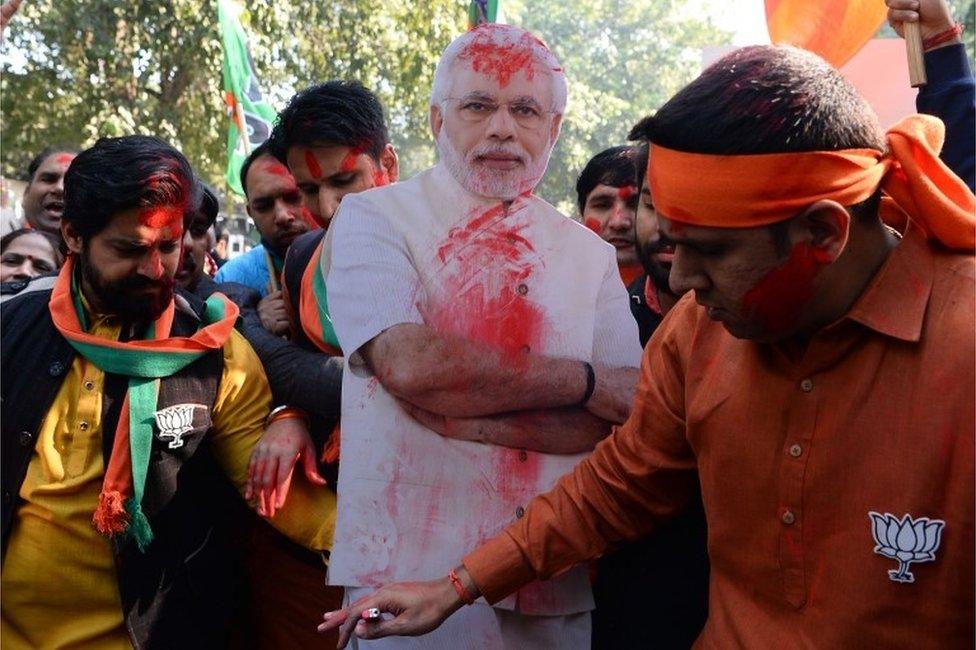 Supporters of India's ruling Bharatiya Janata Party (BJP) celebrate outside the party headquarters in New Delhi on December 18, 2017, with early counting of votes indicating a comfortable win for them in the key states of Gujarat and Himachal Pradesh.