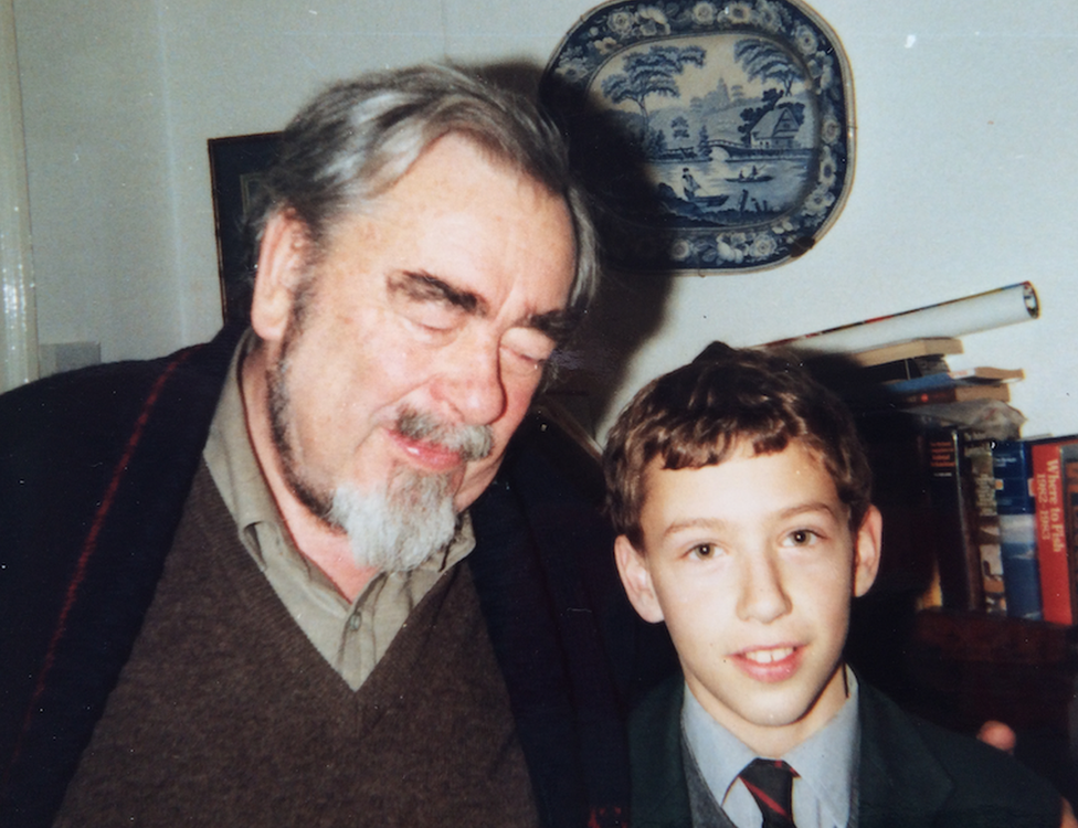 Saul in school uniform with his father