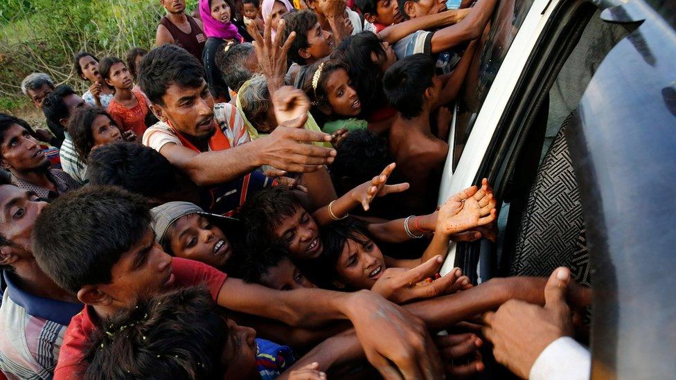 Rohingya refugees stretch their hands for food near Balukhali in Cox's Bazar, Bangladesh, 4 September 2017