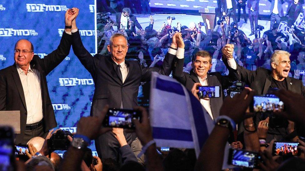 Benny Gantz (2L) celebrates with Moshe Yaalon (L), Gabi Ashkenazi (3L) and Yair Lapid (R) at the Blue and White alliance's headquarters in Tel Aviv on 10 April 2019